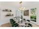 Dining room with a modern light fixture and bold, decorative table and chairs at 3878 Brookside Pkwy, Decatur, GA 30034