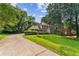 Traditional brick home featuring a spacious front lawn and private driveway at 3878 Brookside Pkwy, Decatur, GA 30034