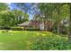 Charming two-story brick home with a manicured lawn and mature trees at 3878 Brookside Pkwy, Decatur, GA 30034