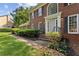 Close-up of a brick home's entrance with a classic white door and manicured landscaping at 3878 Brookside Pkwy, Decatur, GA 30034