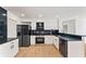 Modern kitchen with stainless steel appliances, black countertops, and white cabinets at 3878 Brookside Pkwy, Decatur, GA 30034