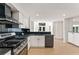 Modern kitchen featuring stainless steel appliances, marble countertops and backsplash at 3878 Brookside Pkwy, Decatur, GA 30034