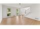 Sunlit living room with hardwood floors and staircase leading to the second floor at 3878 Brookside Pkwy, Decatur, GA 30034