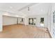 Spacious living room featuring hardwood floors, large windows and a ceiling fan at 3878 Brookside Pkwy, Decatur, GA 30034