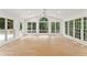 Bright and open space with light wood floors and many windows overlooking the backyard at 3878 Brookside Pkwy, Decatur, GA 30034