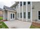 Back patio and home featuring light siding, a bank of windows, and lawn at 5635 Upper Creek Ct, Suwanee, GA 30024
