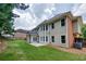 Expansive backyard featuring a large patio area, lush lawn, and mature trees for privacy at 5635 Upper Creek Ct, Suwanee, GA 30024