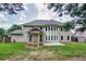 Wide view of rear of home, featuring light siding, patio, lawn, and privacy fence at 5635 Upper Creek Ct, Suwanee, GA 30024