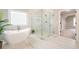 This luxurious bathroom showcases a freestanding tub and a large glass enclosed shower at 5635 Upper Creek Ct, Suwanee, GA 30024