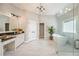 A bright bathroom with a glass-enclosed shower, a soaking tub, double sinks, and a vanity at 5635 Upper Creek Ct, Suwanee, GA 30024