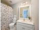 Bathroom featuring a seashell themed shower curtain, toilet, sink, and mirror at 5635 Upper Creek Ct, Suwanee, GA 30024