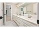 The spacious bathroom features double sinks, white cabinets, and ample counter space at 5635 Upper Creek Ct, Suwanee, GA 30024