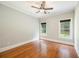 Bedroom features hardwood floors, two windows, and neutral paint at 5635 Upper Creek Ct, Suwanee, GA 30024