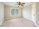 Cozy bedroom with plush carpet, a window letting in natural light, and a neutral color scheme at 5635 Upper Creek Ct, Suwanee, GA 30024