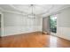 Bright dining room with hardwood floors, decorative molding, and a modern light fixture at 5635 Upper Creek Ct, Suwanee, GA 30024