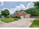Spacious driveway leading to a three-car garage, surrounded by lush greenery and well-maintained landscaping at 5635 Upper Creek Ct, Suwanee, GA 30024