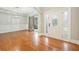 Elegant foyer with gleaming hardwood floors, decorative trim, and a stylish front door with sidelights at 5635 Upper Creek Ct, Suwanee, GA 30024