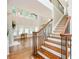 Grand foyer featuring hardwood floors, staircase, and many windows at 5635 Upper Creek Ct, Suwanee, GA 30024