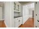 Hallway featuring hardwood floors, built-in cabinets, and a view into dining room at 5635 Upper Creek Ct, Suwanee, GA 30024
