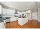 Well-equipped kitchen with stainless steel appliances, center island, and modern finishes at 5635 Upper Creek Ct, Suwanee, GA 30024