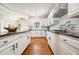 Spacious kitchen featuring white cabinets, an island with dark countertops, and stainless steel appliances at 5635 Upper Creek Ct, Suwanee, GA 30024