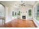 Light-filled living room features hardwood floors, a fireplace, and French doors to the backyard at 5635 Upper Creek Ct, Suwanee, GA 30024