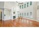 Sun-filled living room with hardwood floors, fireplace, built-in shelves, and large windows at 5635 Upper Creek Ct, Suwanee, GA 30024