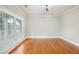Bright living room featuring hardwood floors and large windows providing natural light at 5635 Upper Creek Ct, Suwanee, GA 30024