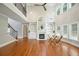 Open-concept living room with fireplace, hardwood floors, and lots of natural light at 5635 Upper Creek Ct, Suwanee, GA 30024