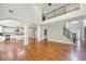 Open-concept living space with hardwood floors, staircase, and view of the kitchen at 5635 Upper Creek Ct, Suwanee, GA 30024