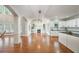 Bright, open-concept living space featuring hardwood floors, fireplace, and kitchen area at 5635 Upper Creek Ct, Suwanee, GA 30024