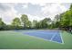 Well-maintained community tennis courts surrounded by lush trees, offering a beautiful recreational space at 5635 Upper Creek Ct, Suwanee, GA 30024