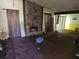 Spacious living room with a stone fireplace, large windows, and a vaulted ceiling at 6255 Mozart Dr, Riverdale, GA 30296