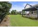 Large, well-maintained backyard with a charming patio, barbecue, and lush green lawn at 4010 Cameron Ct, Cumming, GA 30040
