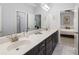 Elegant bathroom featuring double vanity, marble tile floor, and a large mirror at 4010 Cameron Ct, Cumming, GA 30040