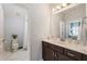 Well-lit bathroom with a vanity and adjacent toilet and shower area at 4010 Cameron Ct, Cumming, GA 30040