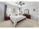 Serene bedroom featuring a large bed, soft carpet, and a ceiling fan at 4010 Cameron Ct, Cumming, GA 30040