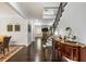 Elegant foyer features dark wood floors, staircase with iron railing, and a view into other living spaces at 4010 Cameron Ct, Cumming, GA 30040