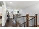Bright hallway with hardwood floors and wrought iron railing on the upper level at 4010 Cameron Ct, Cumming, GA 30040
