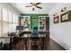 Well-lit home office with built-in bookcases, plantation shutters, and hardwood floors at 4010 Cameron Ct, Cumming, GA 30040