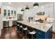 Gourmet kitchen features a large granite island, stainless appliances, and custom white cabinets at 4010 Cameron Ct, Cumming, GA 30040