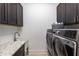 Well-equipped laundry room with modern washer/dryer and ample storage at 4010 Cameron Ct, Cumming, GA 30040