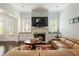 Bright living room with fireplace, built-in cabinets, and hardwood floors at 4010 Cameron Ct, Cumming, GA 30040