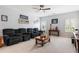 Cozy living room with plush seating, ceiling fan, and bright natural light at 4010 Cameron Ct, Cumming, GA 30040