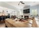 Bright living room boasts a fireplace, large sectional sofa, and is open to kitchen and dining area at 4010 Cameron Ct, Cumming, GA 30040