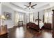 Spacious main bedroom featuring a trey ceiling, hardwood floors, and natural light at 4010 Cameron Ct, Cumming, GA 30040