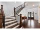 Elegant staircase with dark wood and wrought iron leads to the upper level at 4010 Cameron Ct, Cumming, GA 30040