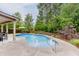 Inviting backyard with a refreshing pool, lush landscaping, and a relaxing outdoor patio area at 470 Wagon Hill Ln, Sugar Hill, GA 30518