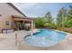 Beautiful backyard with a sparkling pool, patio area, outdoor seating, and well-maintained landscaping at 470 Wagon Hill Ln, Sugar Hill, GA 30518