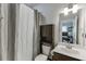 Bathroom featuring tub with shower curtain, toilet, and vanity with storage for a functional design at 470 Wagon Hill Ln, Sugar Hill, GA 30518
